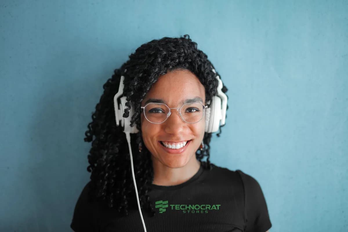 A smiling customer care agent in a headset and a black Technocrat T-shirt